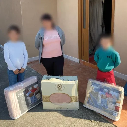 A mother and two children with new blankets