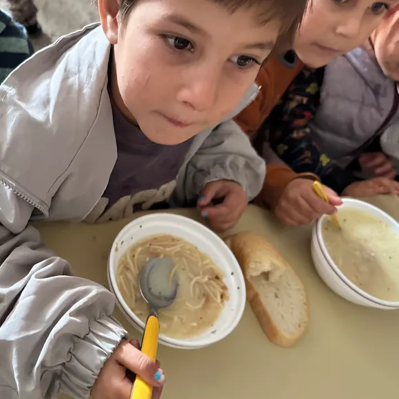 Children enjoying hot meals at a Soup Kitchen