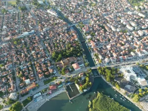 Aerial scene of the island of Struga with bridges and the cityscape on a sunny day, North Macedonia