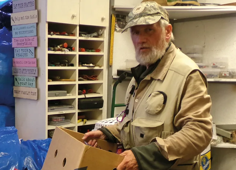 Richard sorting clothes in the church basement