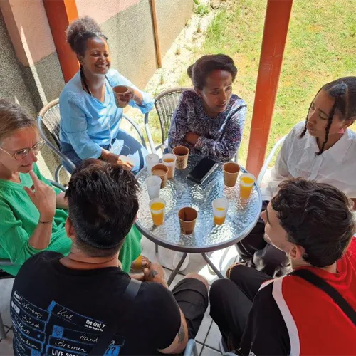 Refugees enjoy coffee and fellowship after the service