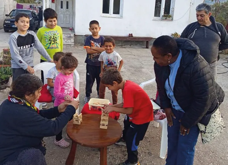 Ruth (front-right) with children playing a game